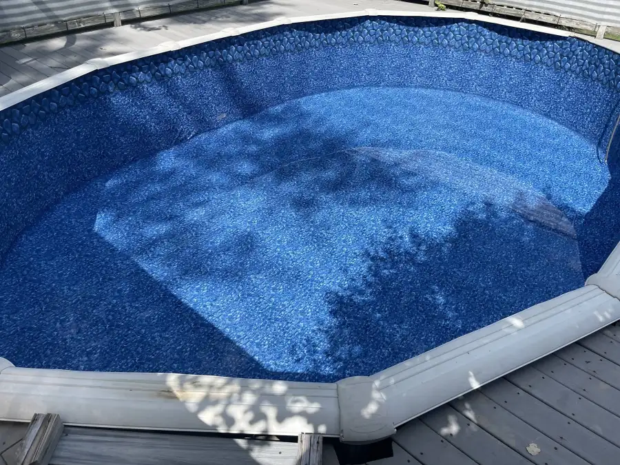 The finished oval pool with its new liner, beginning to fill